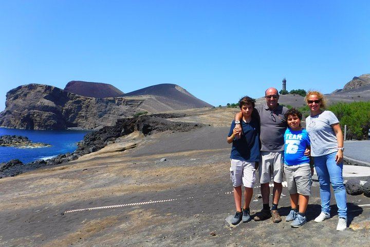 A family enjoying a beautiful sunny day at the Capelinhos Volcano.