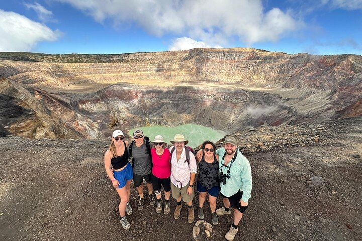 A family from Los Angeles California are posing in front of the santa ana volcano crater