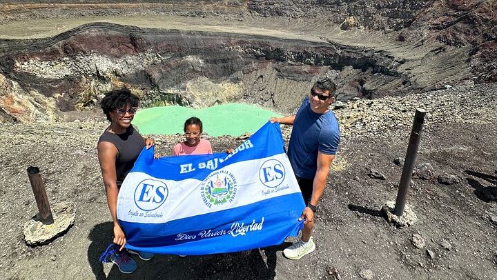 A family from the US is posing for their Santa Ana Volcano photo