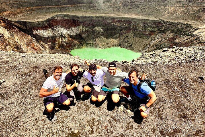a group of surfers from Brazil are posing in front of the santa ana volcano crater