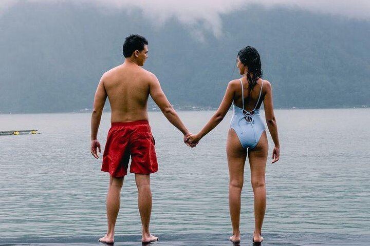A romantic moment by the stunning Lake Batur at Batur Natural Hot Spring after sunrise tour