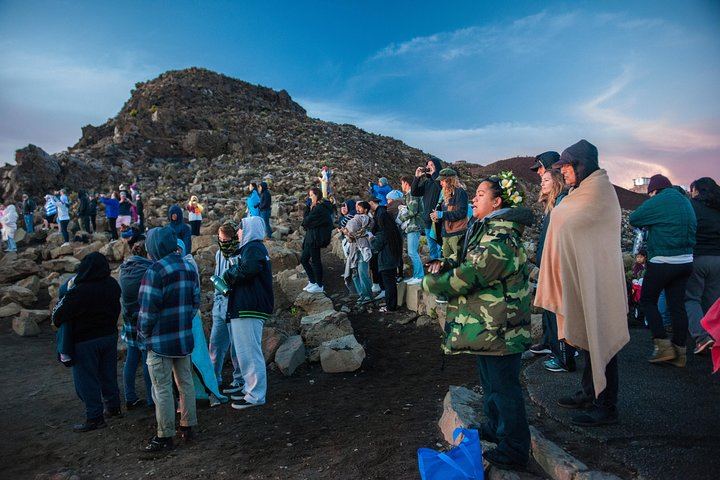 Blankets and beanies warm a group of onlookers atop Mount Haleakala, Maui where temperatures drop considerably.