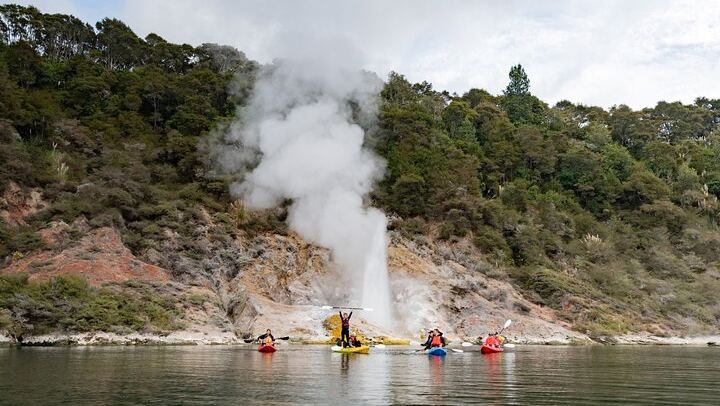 Cheering in front of geyser on Lake Rotomahana
