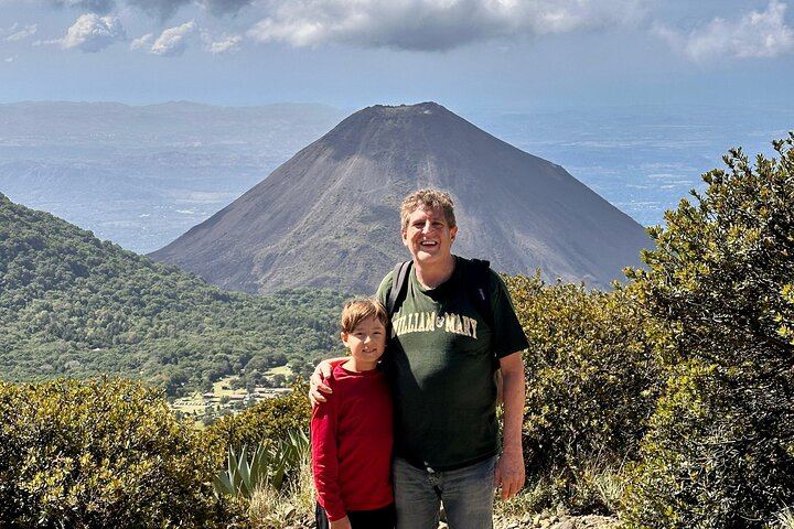 dad and son are hiking the santa ana volcano