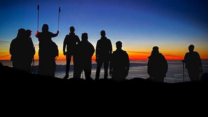 First light after a night climb — unforgettable moments above the clouds.