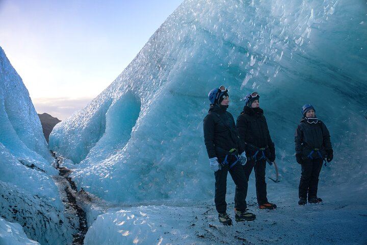 Guests navigate sparkling blue ice formations and natural crevasses during a guided glacier hike