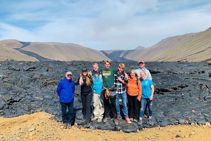 Happy family taking a picture at the lava valley.