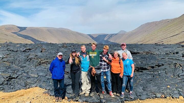 Happy family taking a picture at the lava valley.