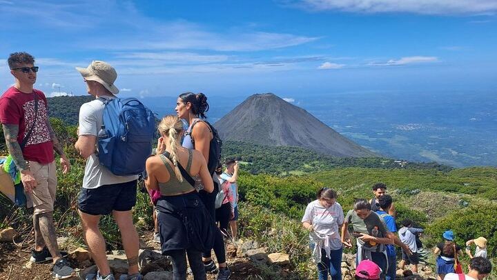 Hike to the majestic Santa Ana Volcano crater, with the stunning Izalco Volcano in the background. A unique experience for adventure and nature lovers!