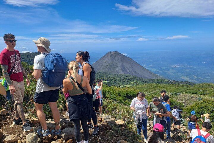 Hike to the majestic Santa Ana Volcano crater, with the stunning Izalco Volcano in the background. A unique experience for adventure and nature lovers!