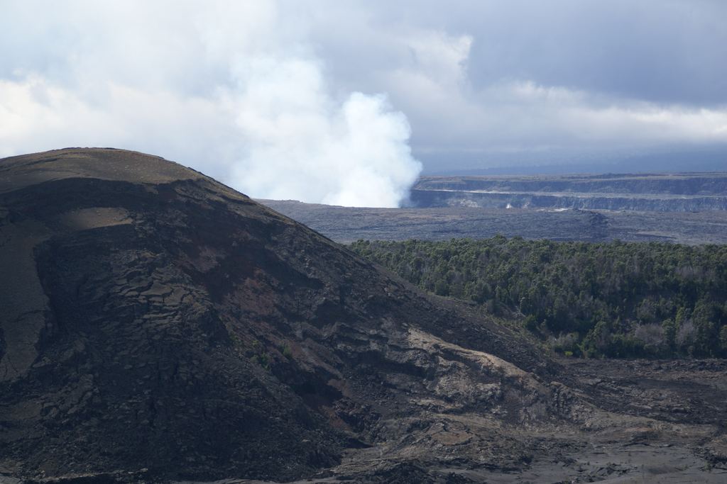 Kīlauea Iki crater and the main Kīlauea caldera seen together from the rim path in Hawaiʻi Volcanoes National Park