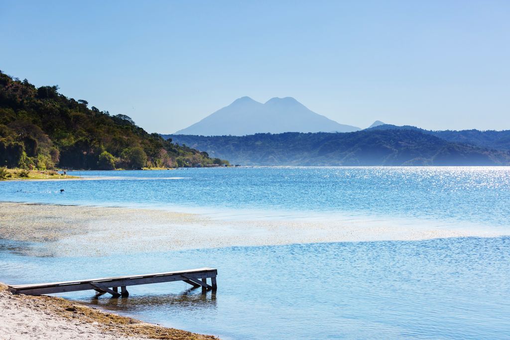 Lake Coatepeque seen from its shore in western El Salvador, with wooded caldera walls around the water