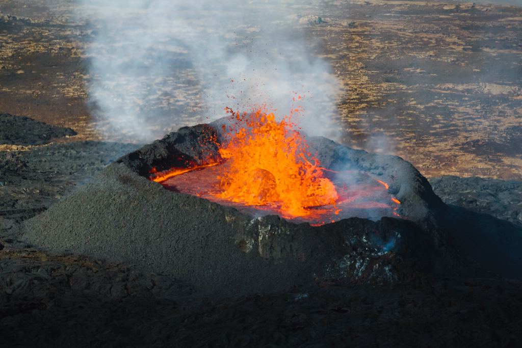 A lava lake photographed from above, with molten rock circulating between plates of dark cooled crust