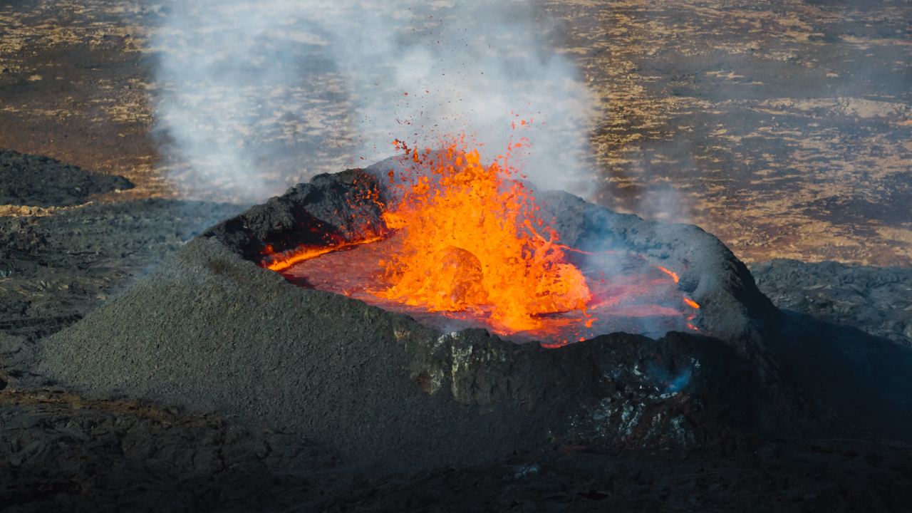 A lava lake photographed from above, with molten rock circulating between plates of dark cooled crust