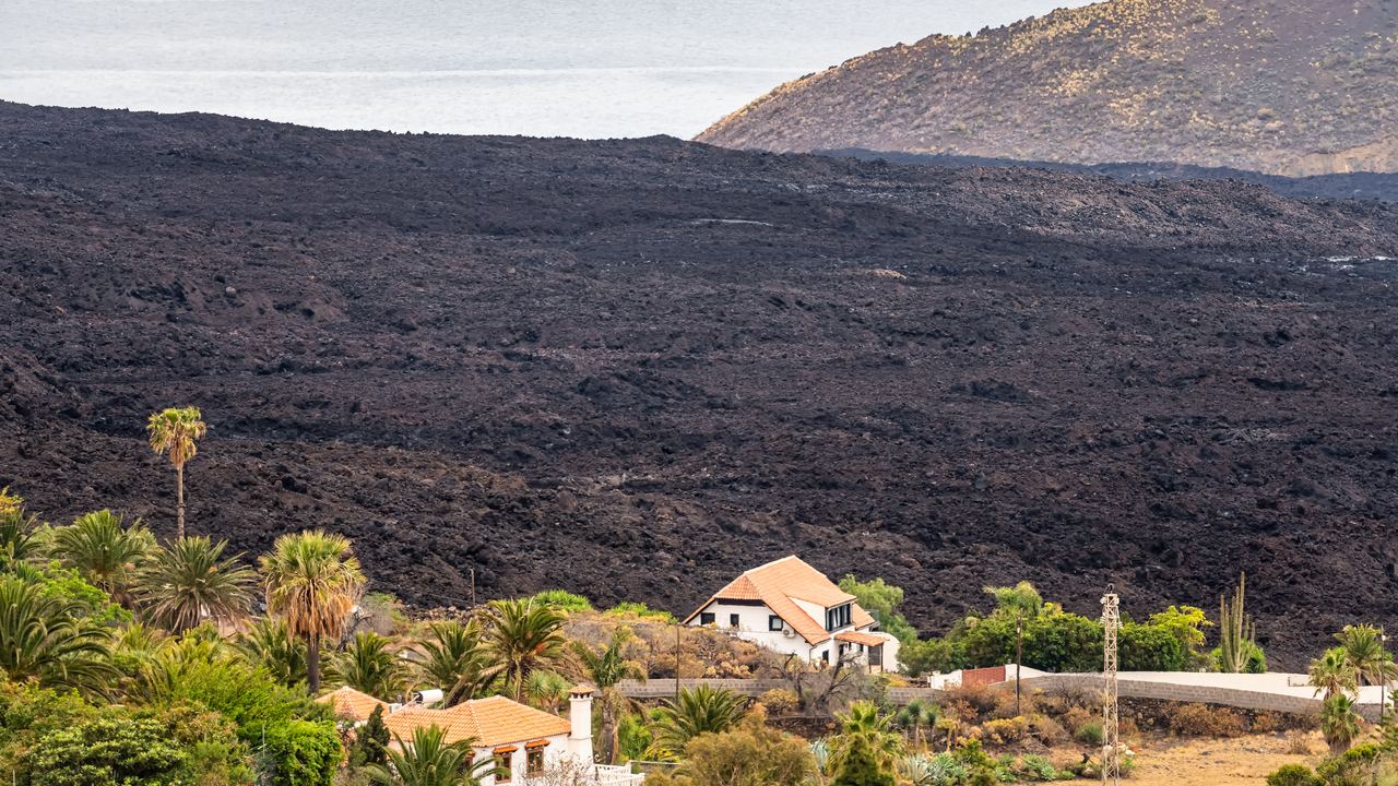 A tongue of solidified lava from the 2021 La Palma eruption covering houses in the Aridane valley
