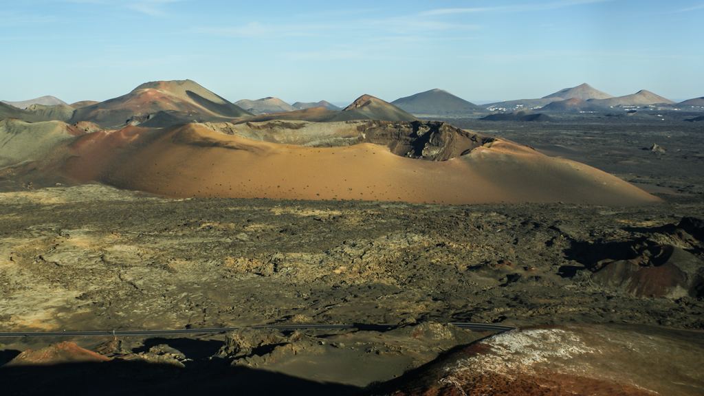 The red and ochre volcanic slopes of the Fire Mountains in Timanfaya National Park, Lanzarote