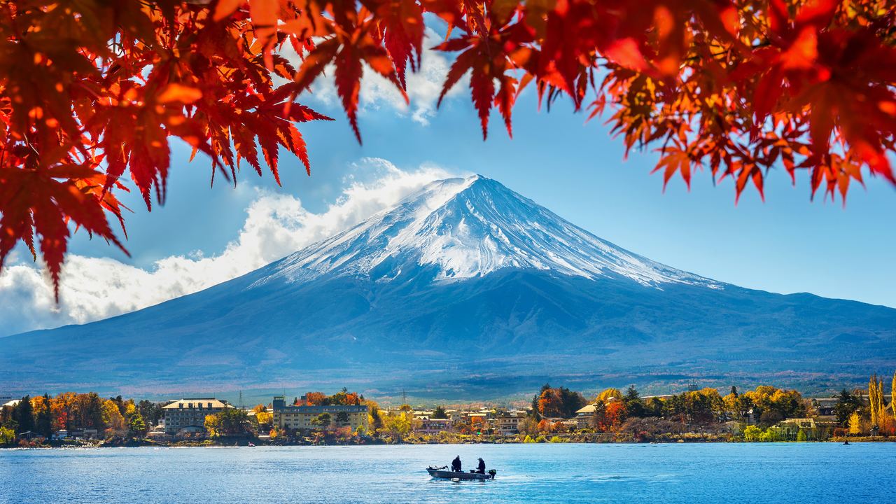 Mount Fuji above Lake Kawaguchiko framed by autumn foliage, Yamanashi, Japan
