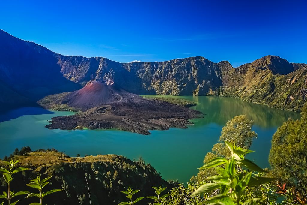 The cone and caldera rim of Mount Rinjani rising above Lombok, Indonesia