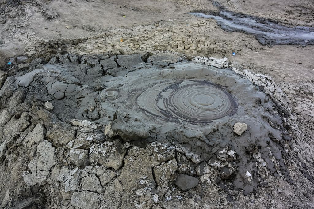 A grey mud cone with a pool of thick mud at its summit in the Gobustan field near Baku, Azerbaijan