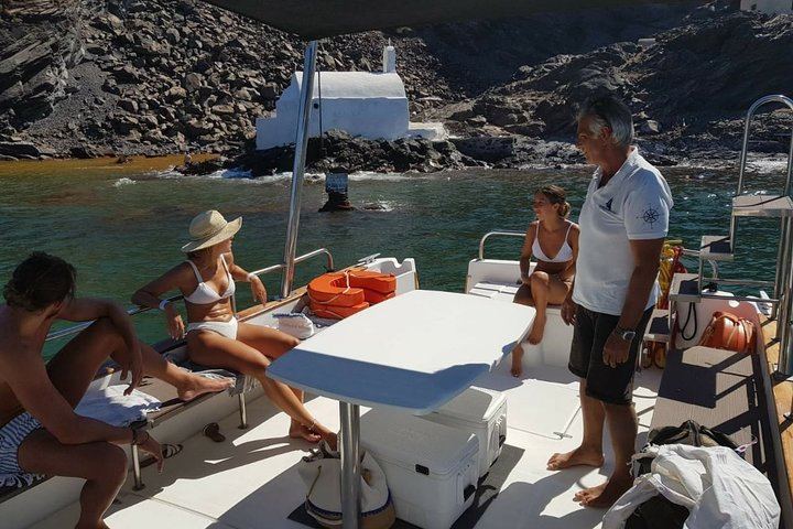 Our boat tour stops near the coast of Palia Kameni, the volcanic island in Santorini, for people to swim in the natural, sulfur-rich hot springs. The water is warm and orange-tinted.