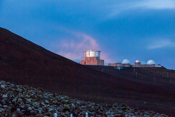 Rays of sunshine highlight the University of Hawaii Observatories, which sit at the summit of Mount Haleakala, Maui.