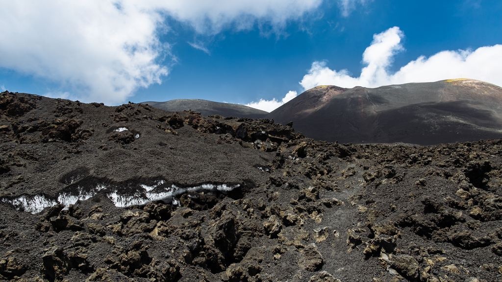Snow under a layer of volcanic ash near the summit of Mount Etna