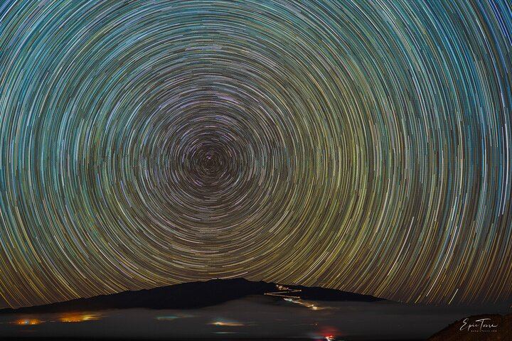 Star Trails over the mountain - This is a stack of 400 photos blended together to show you the rotation of Earth.