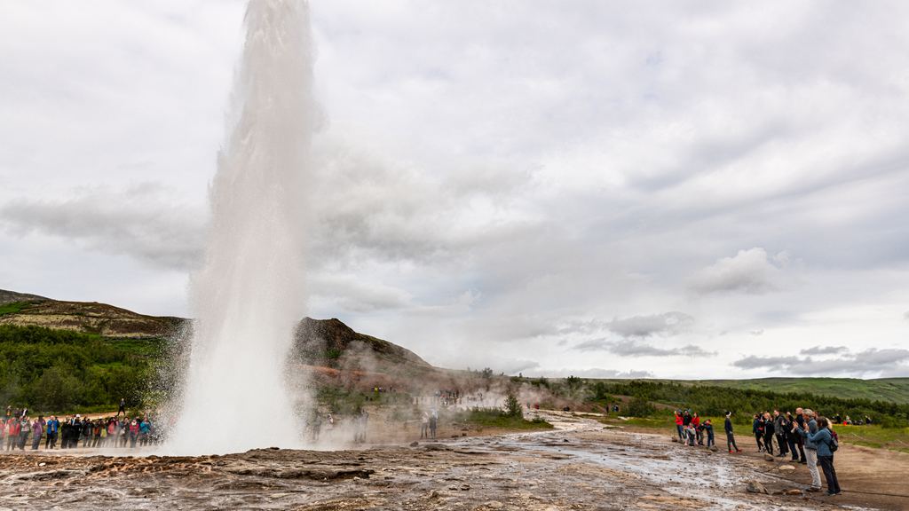 The Strokkur geyser throwing a column of boiling water into the air, Haukadalur, Iceland