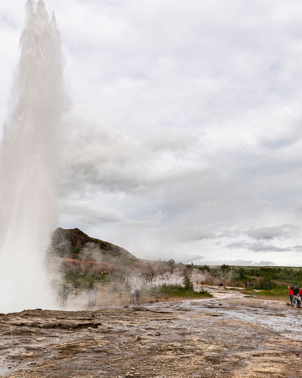 The Strokkur geyser throwing a column of boiling water into the air in the Haukadalur geothermal field, Iceland