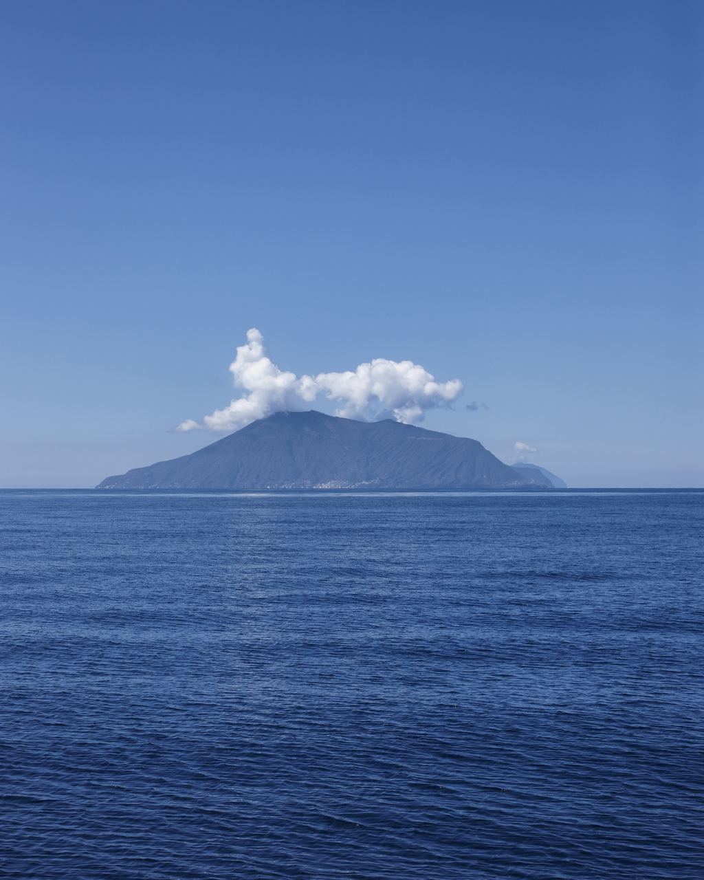 The cone of Stromboli rising straight out of the Tyrrhenian Sea, Aeolian Islands, Sicily
