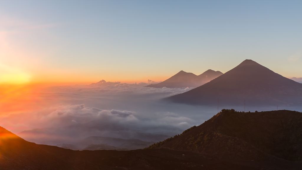 Sunset seen from the Pacaya, with volcanic cones rising above a sea of cloud to the north west