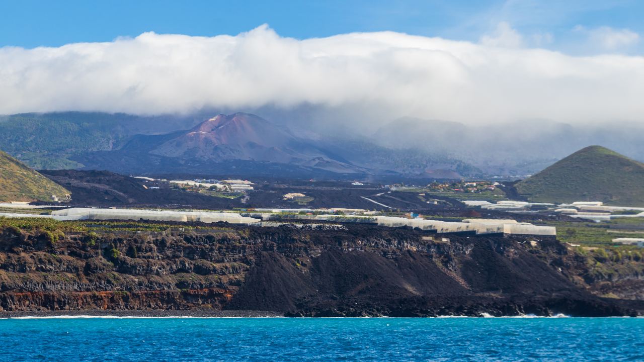 The cone of the Tajogaite volcano on La Palma seen from the sea near the lava delta, Canary Islands
