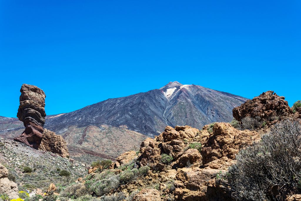 The Teide volcano seen behind the Roques de Garcia rock formations in Teide National Park, Tenerife