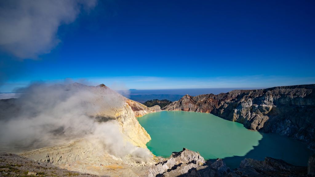 The turquoise acid crater lake of Kawah Ijen seen from above at sunrise