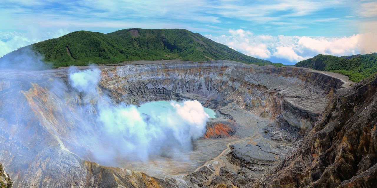 The turquoise acid lake inside the active crater of Poás Volcano, Costa Rica