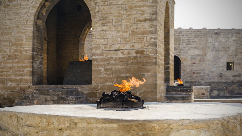 The stone fire altar burning in the courtyard of the Ateshgah temple at Surakhani, Azerbaijan