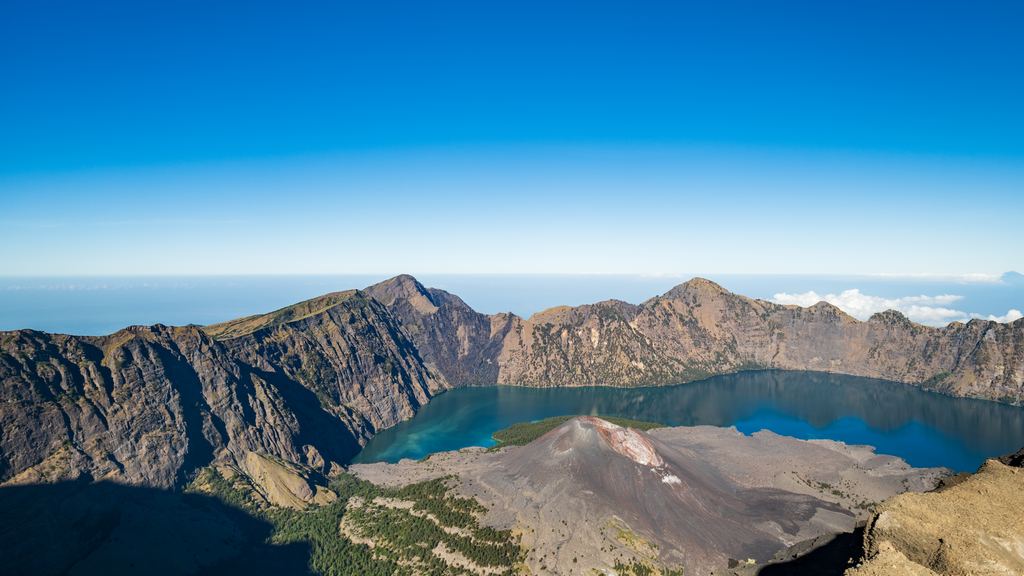 The caldera of Mount Rinjani with the Segara Anak lake, seen from the summit