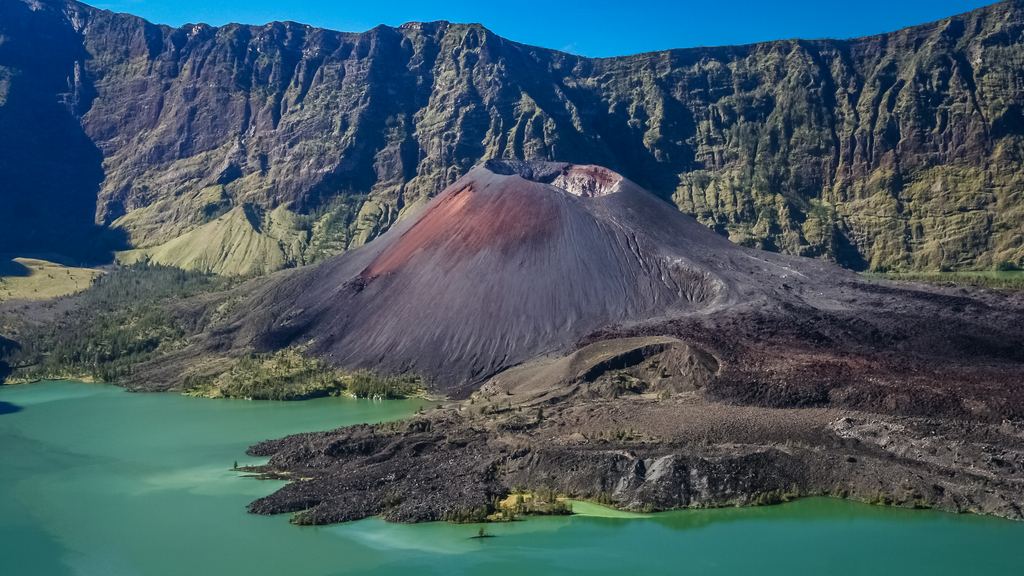 The Segara Anak lake and its shoreline seen from the caldera wall of Mount Rinjani