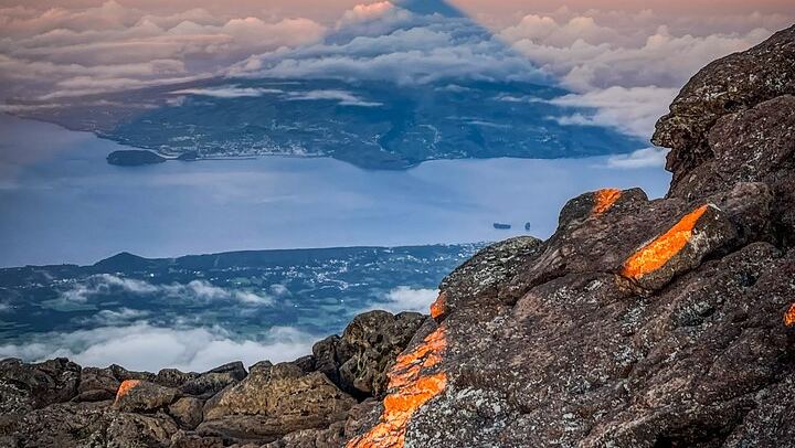 The shadow of Mount Pico painted on the morning sky — a night climb that ends in pure wonder.