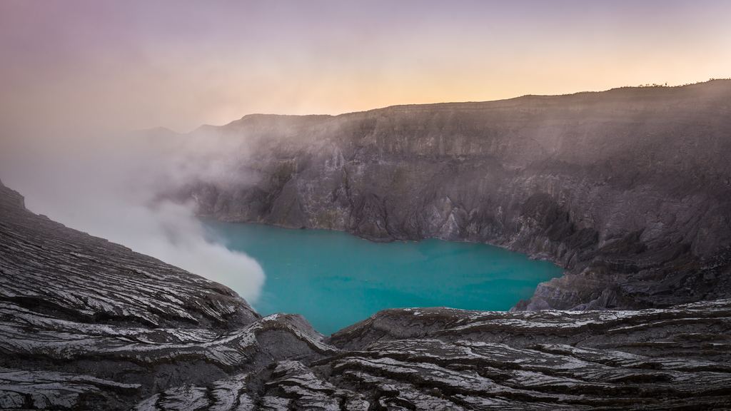 The turquoise acid crater lake of Kawah Ijen seen from the rim above it