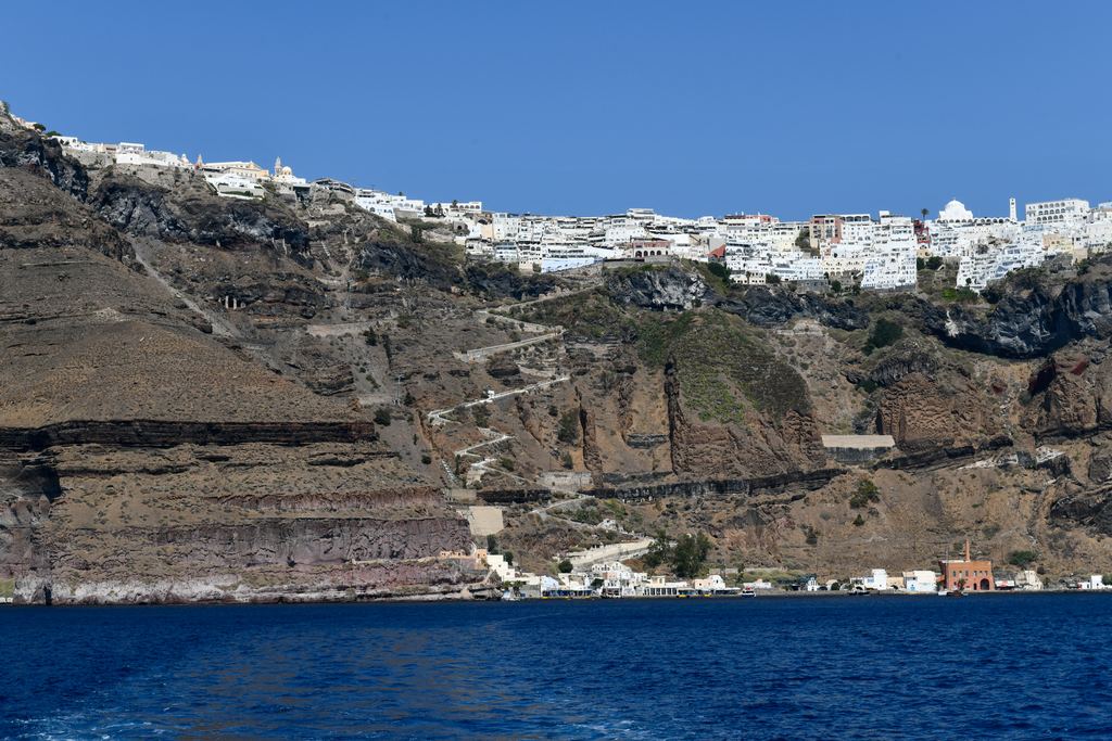 The caldera and the cliffs of Santorini seen from the summit path on Nea Kameni
