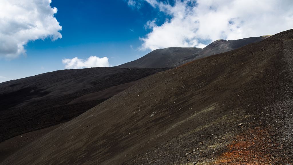 Loose black volcanic rock and scoria on the slopes of Mount Etna