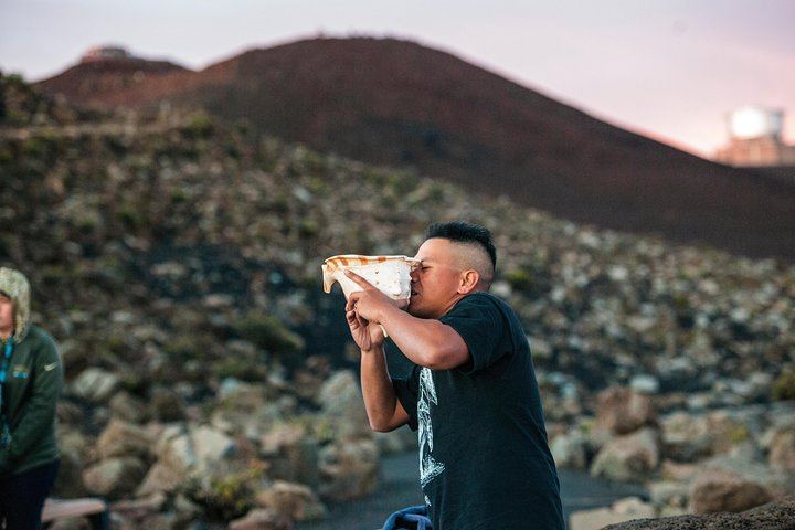 Visitor gets up, close, and personal with a huge sea shell at Mount Haleakala, Maui.