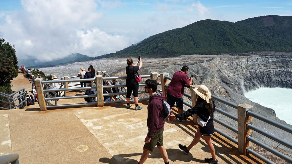 Visitors at the fenced crater lookout at Poás Volcano National Park, Costa Rica